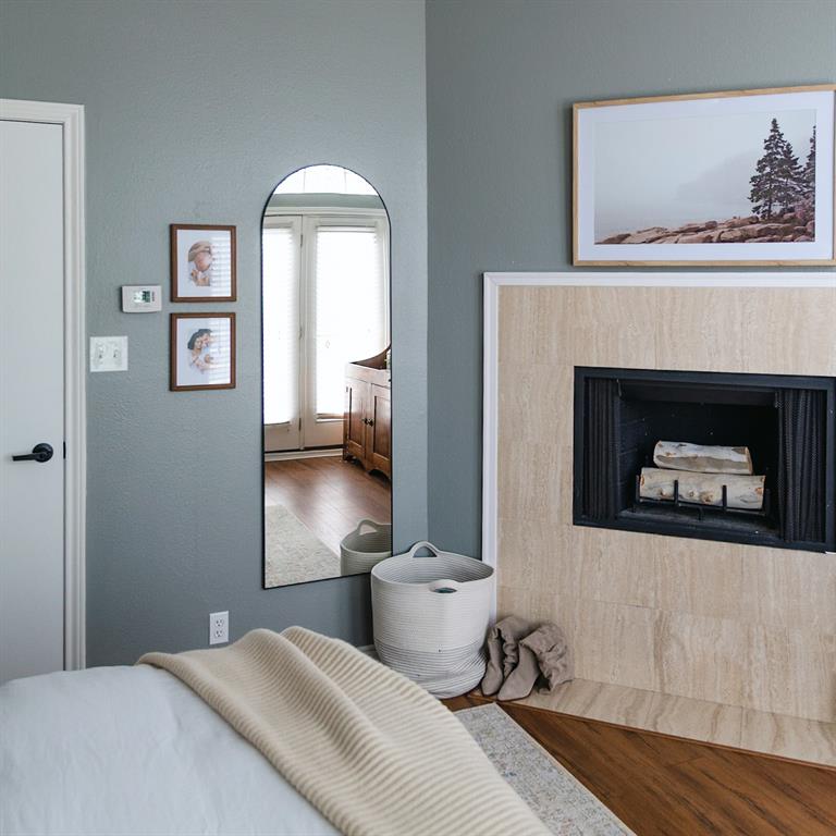 4040 Avondale Avenue, Unit 107 Dallas, TX 75219 - Photo 16 of 33 a bedroom with a bed and a fireplace