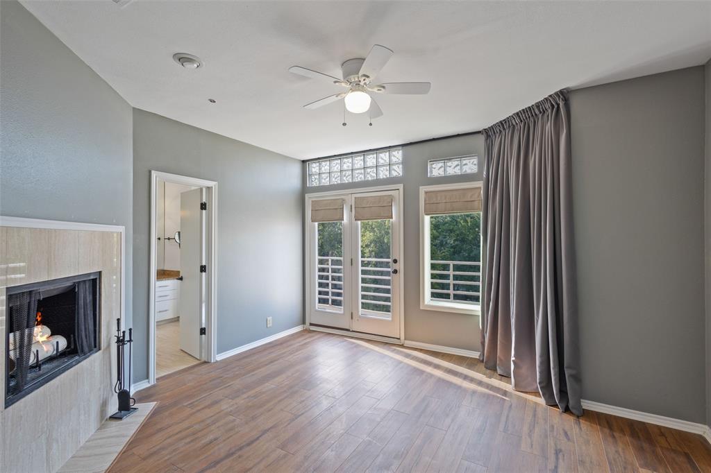 4040 Avondale Avenue, Unit 107 Dallas, TX 75219 - Photo 20 of 33 a view of an empty room with a window and wooden floor