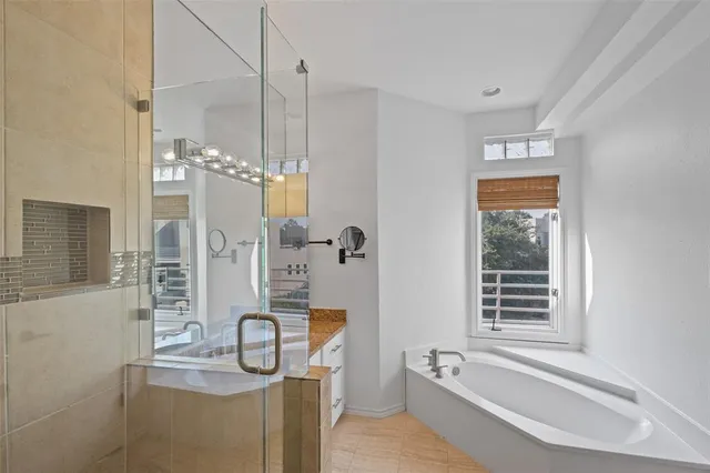 a bathroom with a granite countertop sink a mirror and shower