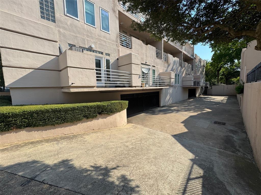 4040 Avondale Avenue, Unit 107 Dallas, TX 75219 - Photo 27 of 33 a view of a white house with a yard