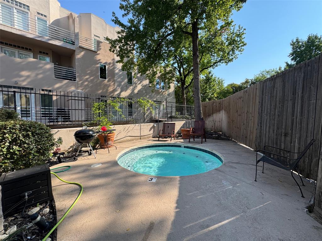 4040 Avondale Avenue, Unit 107 Dallas, TX 75219 - Photo 29 of 33 a view of a swimming pool with a patio