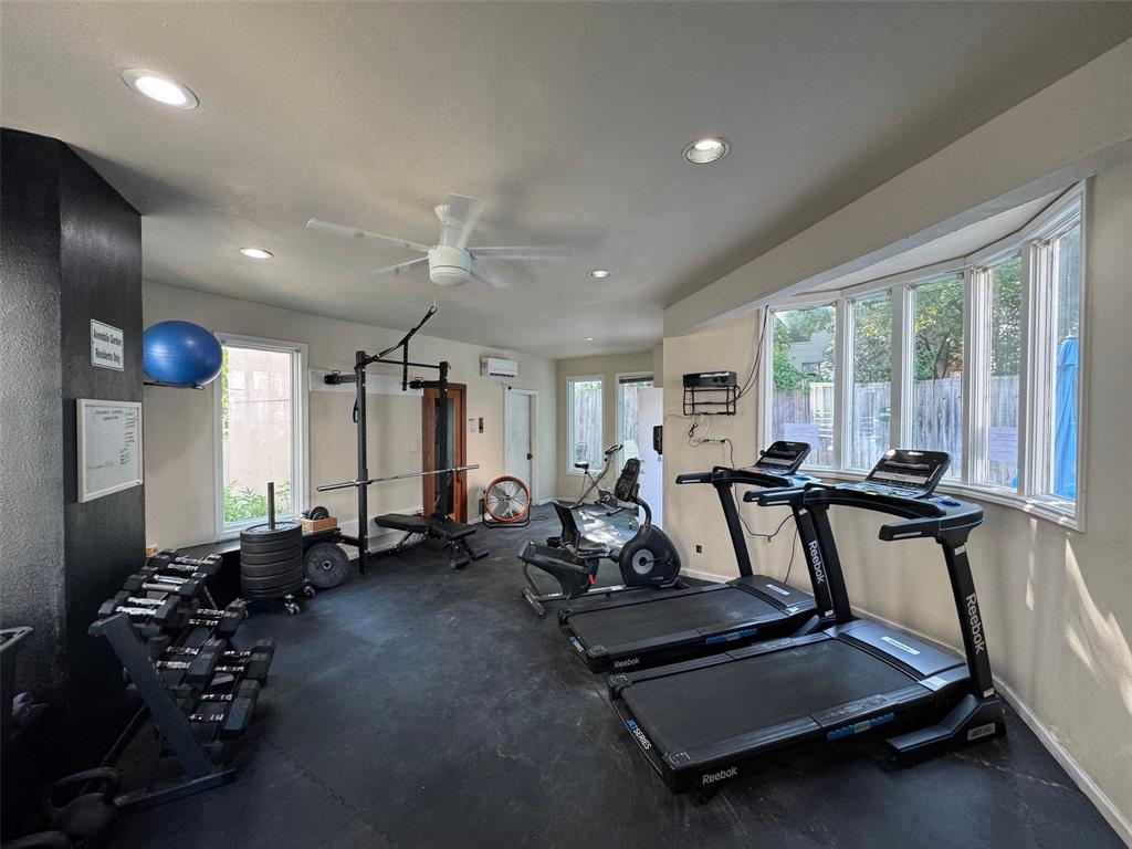 4040 Avondale Avenue, Unit 107 Dallas, TX 75219 - Photo 30 of 33 a room with gym equipment and large mirror
