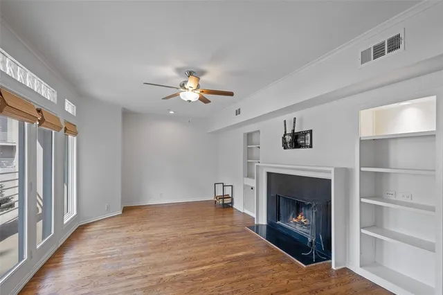 a view of an empty room with a fireplace and a window