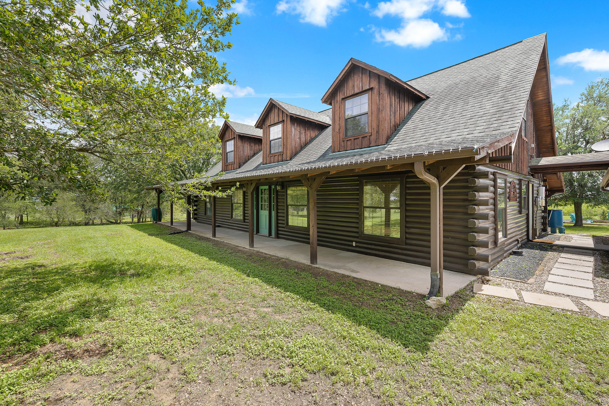 571 Balch Road Elgin, TX 78621 - Photo 3 of 33 Log-style exterior with a covered front porch featuring wood posts