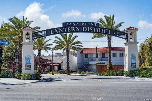 a front view of multi story residential apartment building with yard and sign board