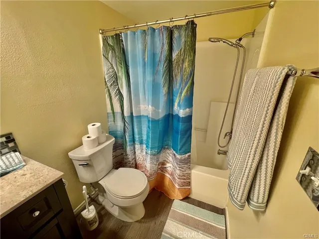 a bathroom with a toilet and shower