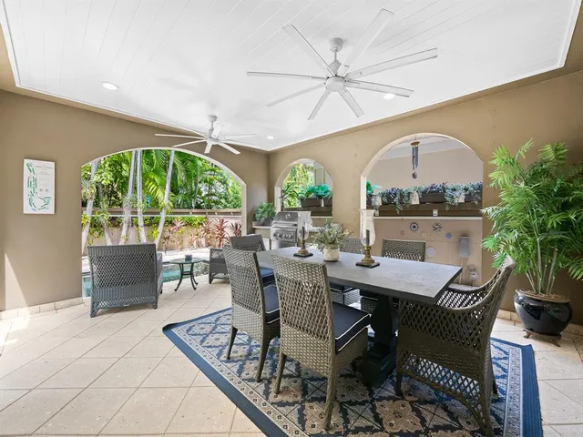 a living room with patio furniture and a large window
