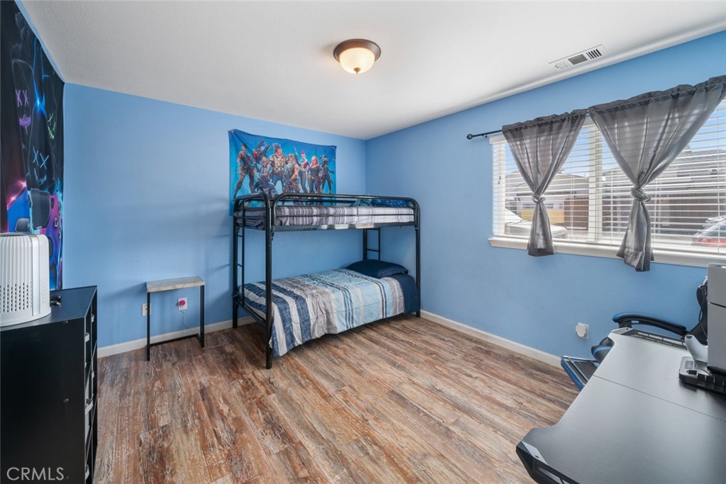 1681 Ocean Street Oceano, CA 93445 - Photo 16 of 25 a bedroom with a bed and wooden floor