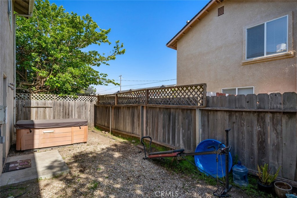 1681 Ocean Street Oceano, CA 93445 - Photo 24 of 25 a backyard of a house with chairs and wooden fence