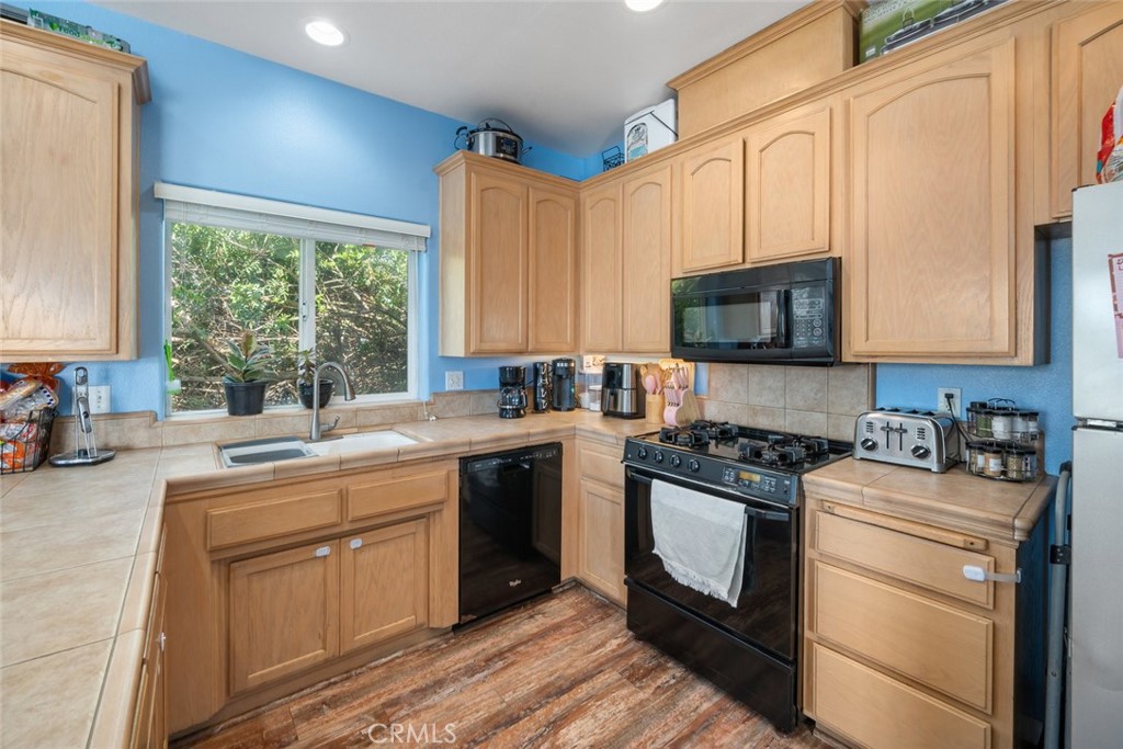 1681 Ocean Street Oceano, CA 93445 - Photo 8 of 25 a kitchen with stainless steel appliances granite countertop white cabinets granite counter tops and a window