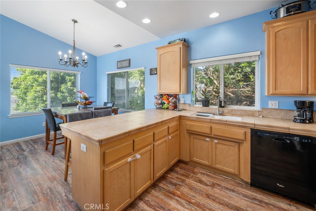 1681 Ocean Street Oceano, CA 93445 - Photo 9 of 25 a kitchen with a stove a sink dishwasher a kitchen island with wooden cabinets and floor