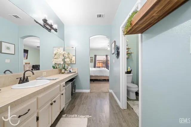 a spacious bathroom with a double vanity sink and a mirror