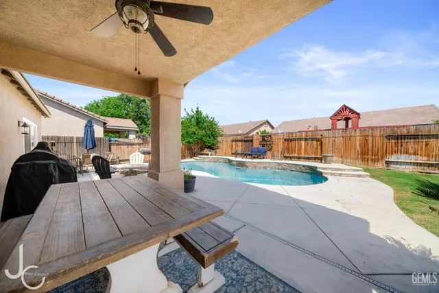 a view of a white house with a yard