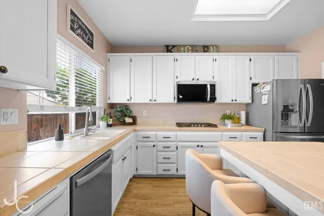 a kitchen with a refrigerator stove and sink