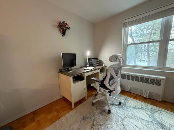 a view of a room with workspace and windows