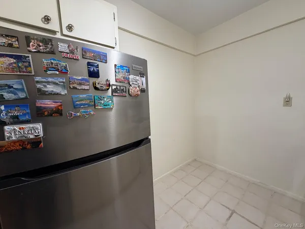 a bedroom with a bed window and a chandelier