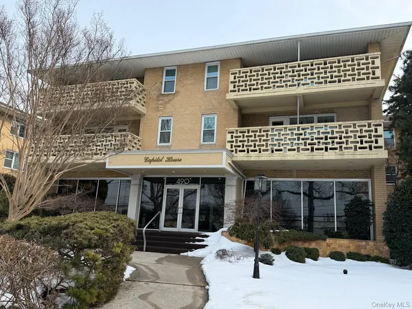 a front view of a house with a large window