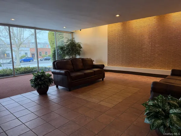 a living room with furniture and a floor to ceiling window