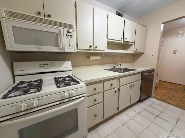 a kitchen with cabinets and appliances
