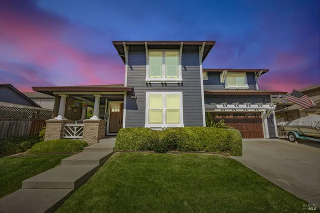 a front view of a house with a garden
