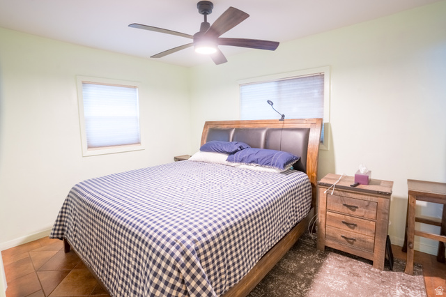 186 West Center Street Moab, UT 84532 - Photo 8 of 15 Bedroom featuring a ceiling fan with integrated lighting, two windows with blinds, and tile flooring