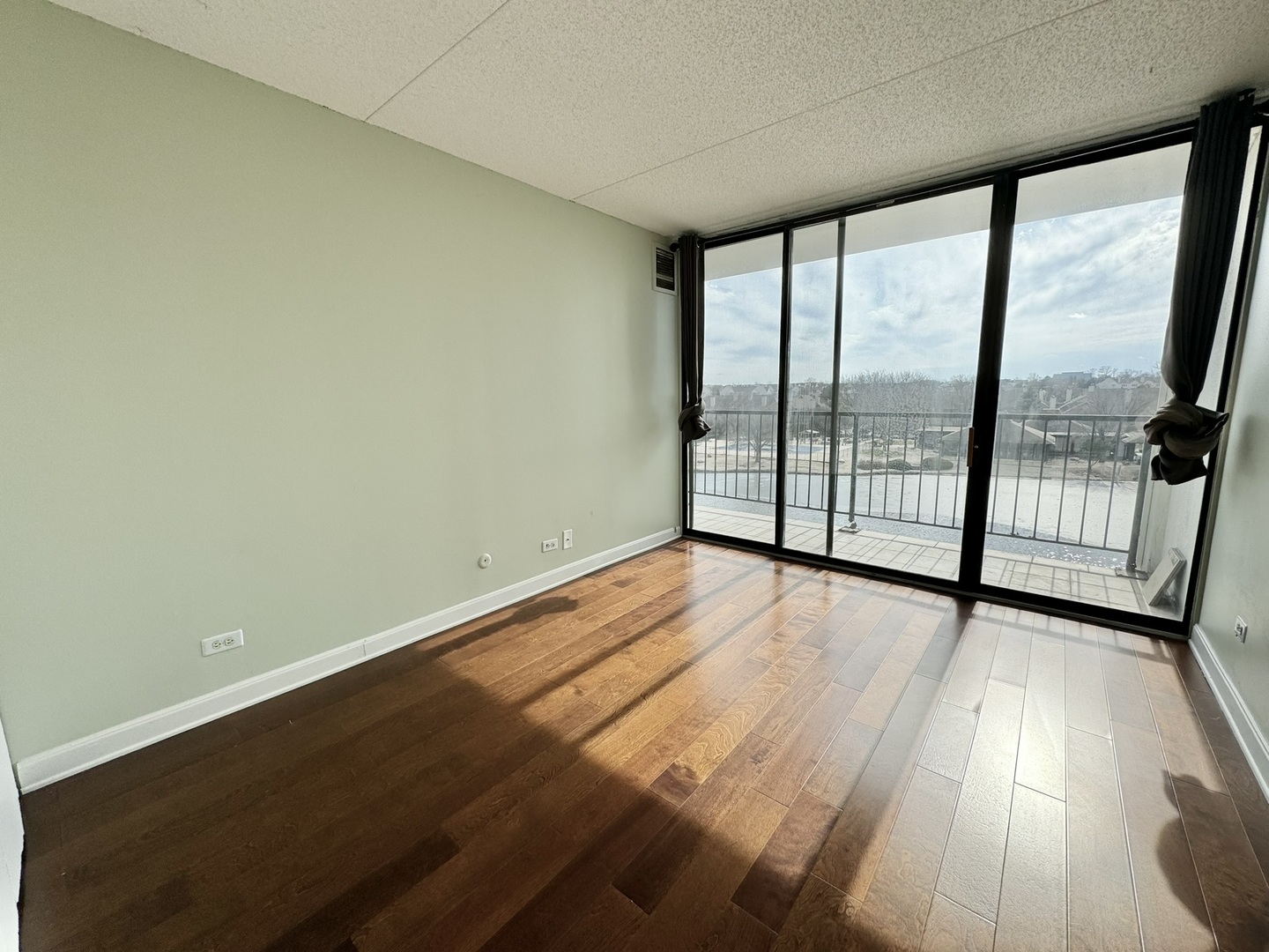 2015 South Finley Road, Unit 407 Lombard, IL 60148 - Photo 15 of 23 an empty room with wooden floor and sliding door