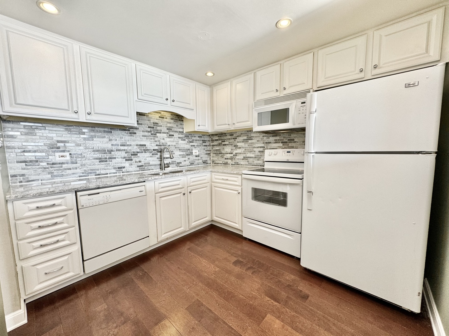 2015 South Finley Road, Unit 407 Lombard, IL 60148 - Photo 2 of 23 a kitchen with white cabinets and white appliances