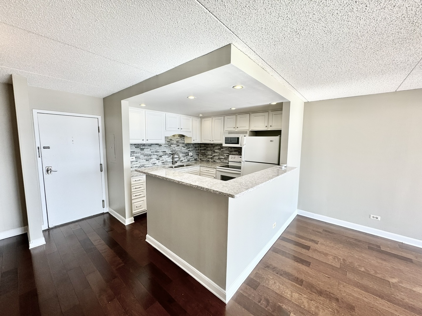 2015 South Finley Road, Unit 407 Lombard, IL 60148 - Photo 3 of 23 a kitchen with stainless steel appliances granite countertop a refrigerator and a stove top oven