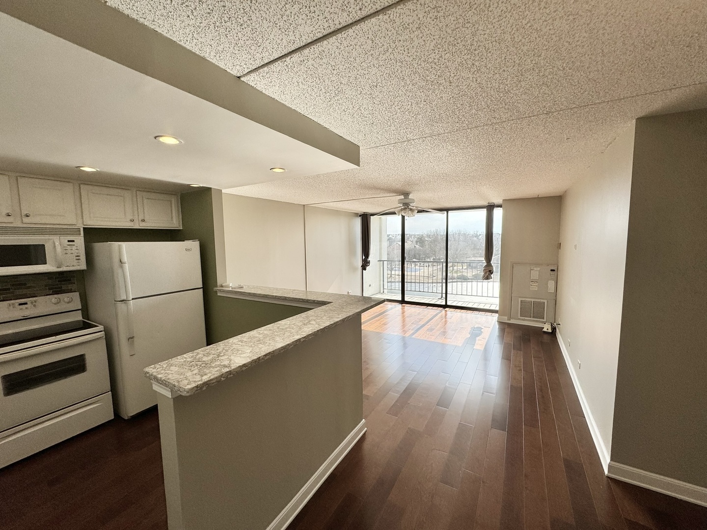 2015 South Finley Road, Unit 407 Lombard, IL 60148 - Photo 4 of 23 a view of a kitchen with wooden floor and stainless steel appliances