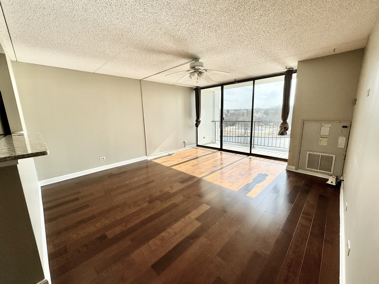 2015 South Finley Road, Unit 407 Lombard, IL 60148 - Photo 5 of 23 a view of an empty room with wooden floor and a window