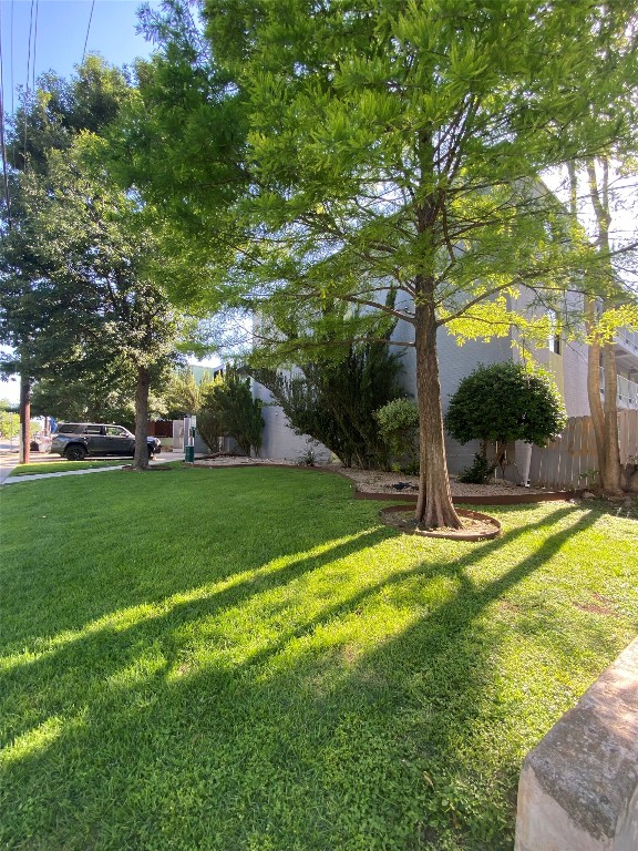 2408 Leon Street, Unit 303 Austin, TX 78705 - Photo 5 of 6 a view of a house with a big yard and large trees