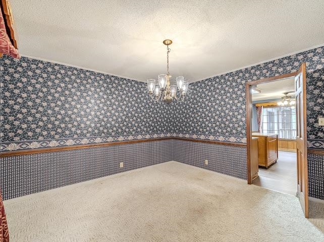 660 Hinton Road Counce, TN 38326 - Photo 14 of 40 Ceiling-mounted chandelier, patterned wallpaper, wall trim, carpet flooring, wood-finish door frame