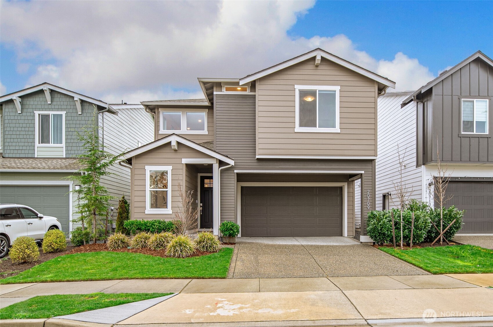 20709 137th Street Southeast Monroe, WA 98272 - Photo 1 of 40 a front view of a house with a yard and garage