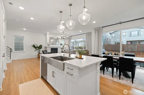 an open kitchen with a table and chairs