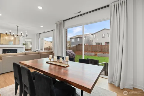 a view of a dining room with a table and chairs