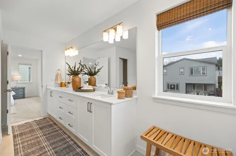a bathroom with a sink a mirror and a vanity