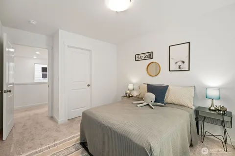 a bedroom with a bed and lamp