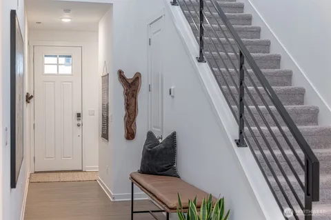 a view of staircase with white walls and stairs