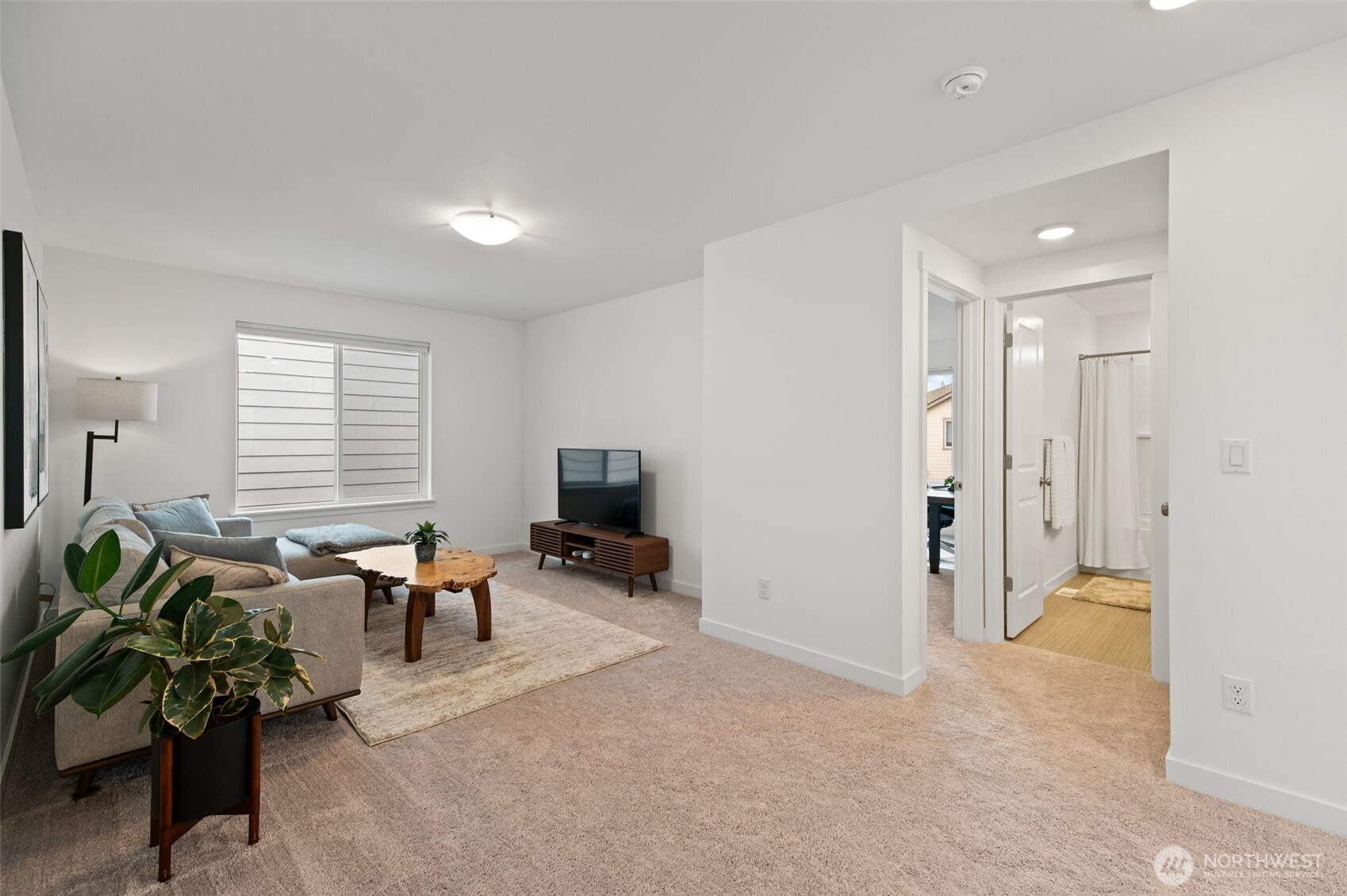 20709 137th Street Southeast Monroe, WA 98272 - Photo 33 of 40 a living room with furniture a potted plant and a flat screen tv