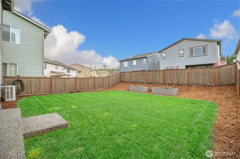 a view of a backyard with a garden and deck