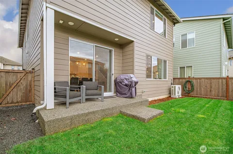 a view of a house with a backyard and a patio