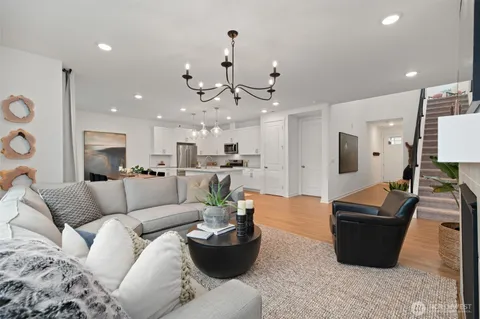 a living room with furniture and kitchen view
