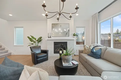 a living room with furniture a fireplace and a table