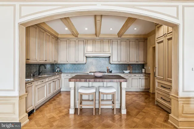 a kitchen with stainless steel appliances granite countertop a stove a sink and a white cabinets
