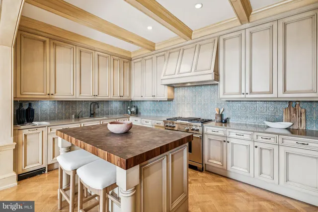a kitchen with granite countertop a stove sink and cabinets