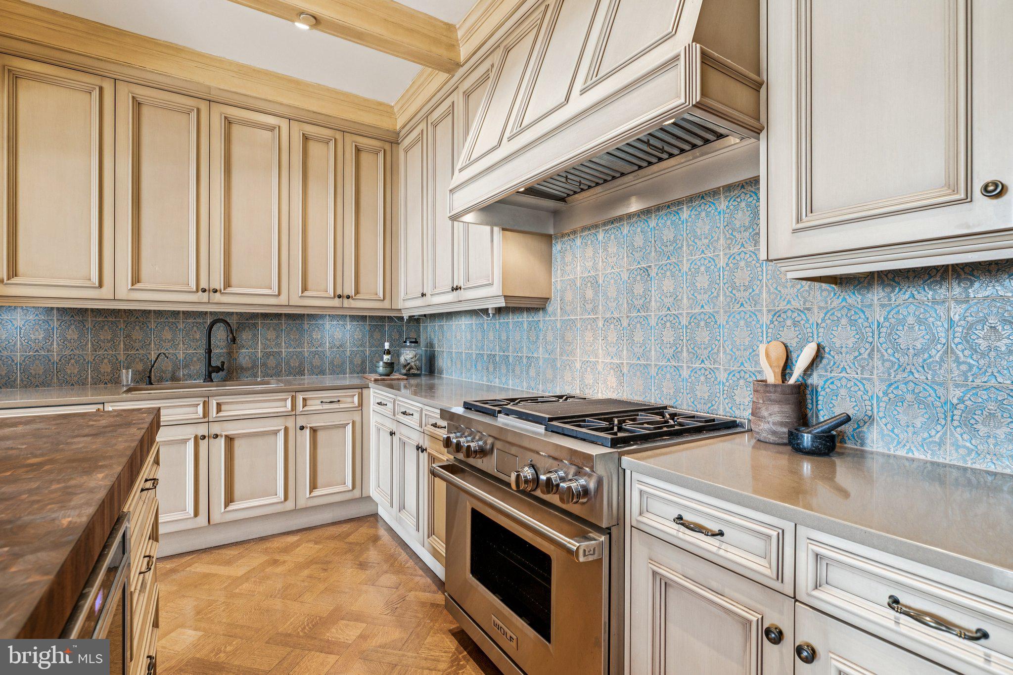 421 Chestnut Street, Unit 401 Philadelphia, PA 19106 - Photo 14 of 36 a kitchen with granite countertop a stove sink and cabinets