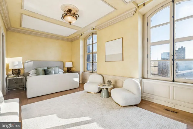 a bedroom with a bed couch and dresser