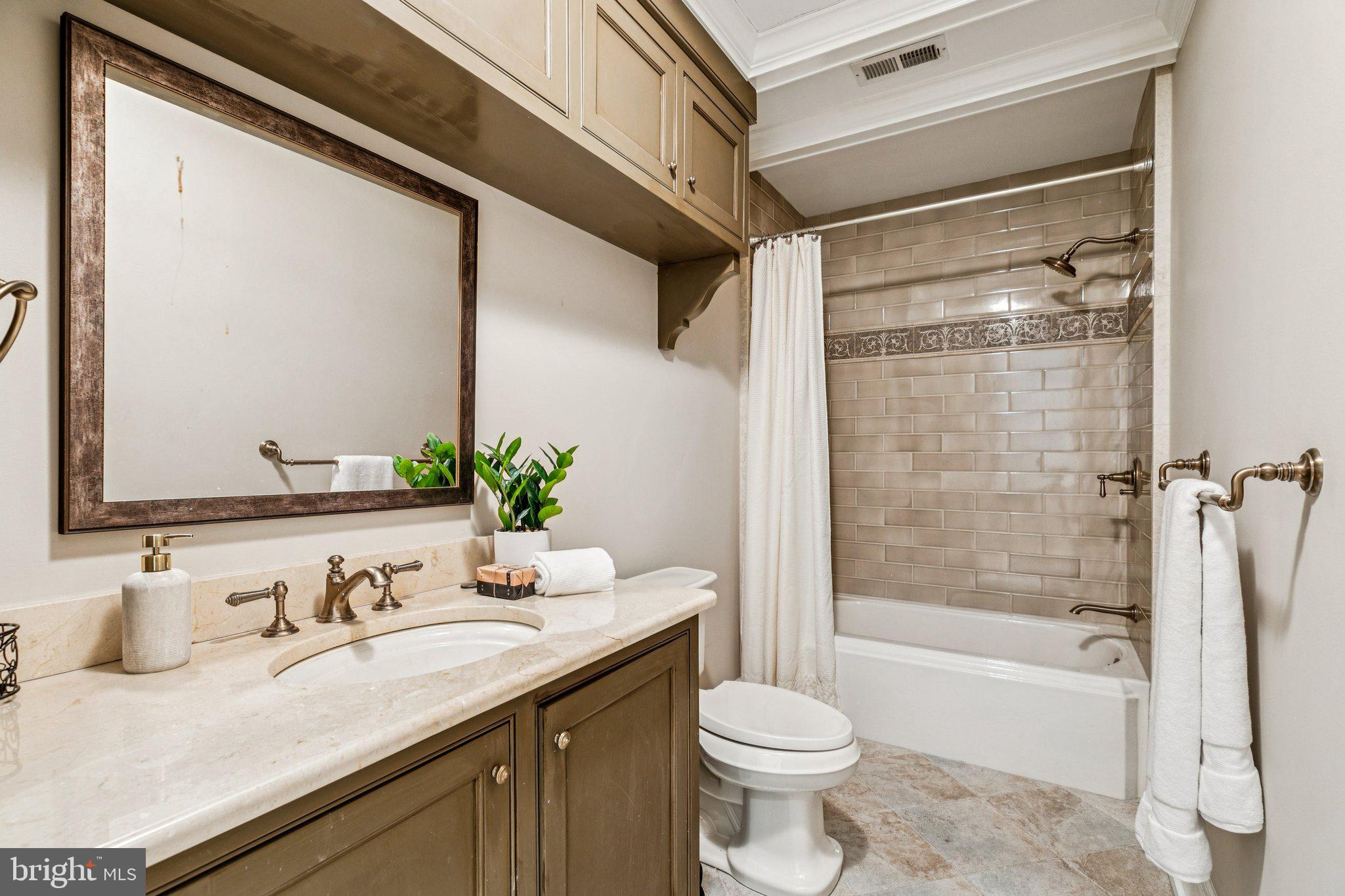 421 Chestnut Street, Unit 401 Philadelphia, PA 19106 - Photo 25 of 36 a bathroom with a granite countertop sink toilet and shower