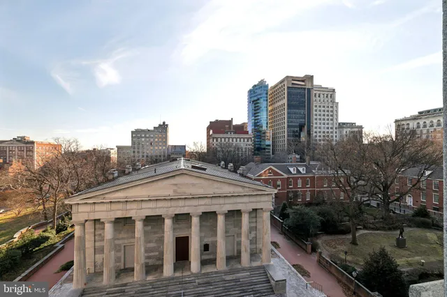 a living room with lots of furniture and a large window
