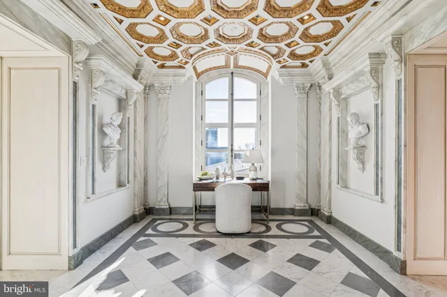 a living room with a black white checkered floor next to a window and a rug